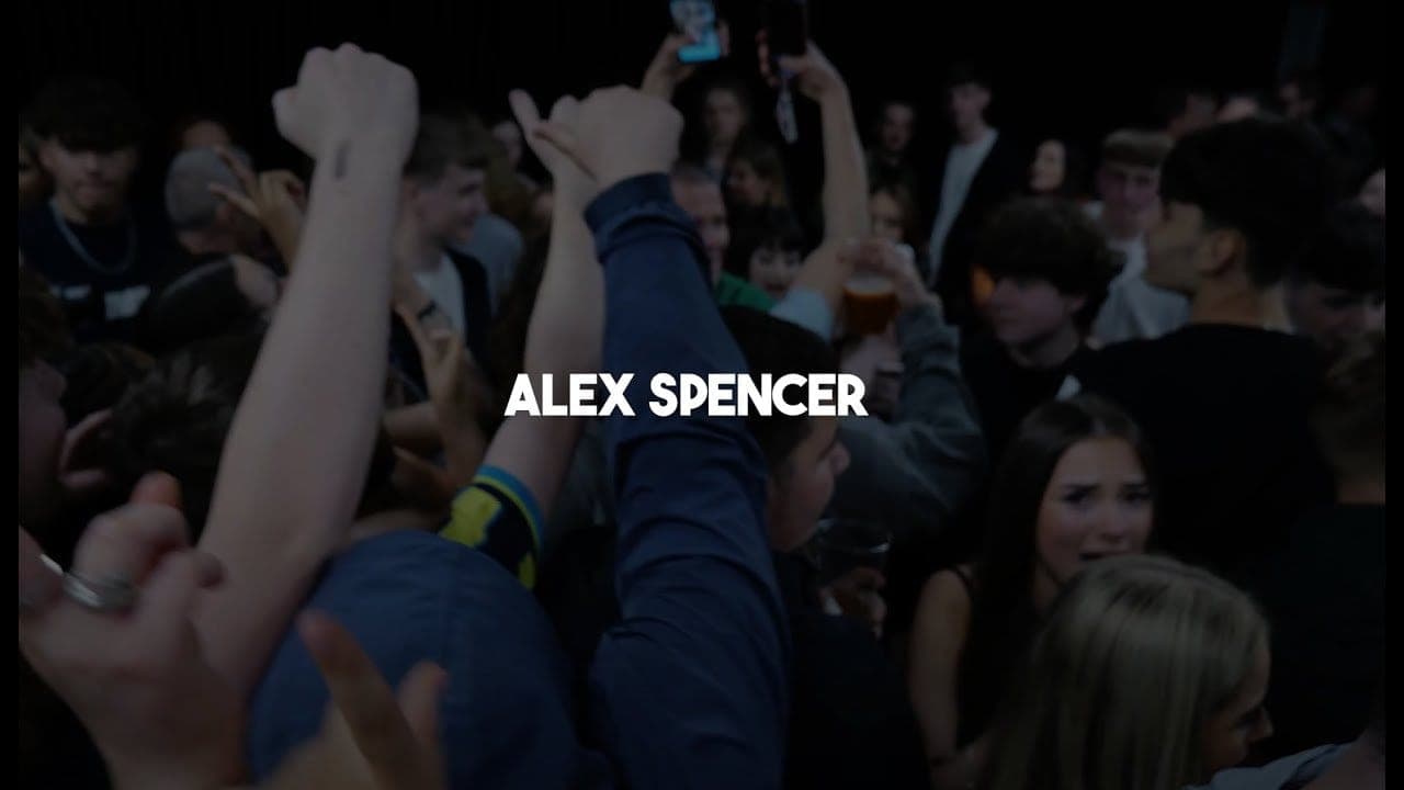 Crowd at The Academy with the title “Alex Spencer” over the footage